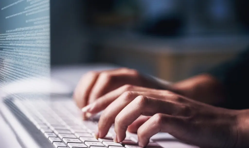 cropped-hand-using-laptop